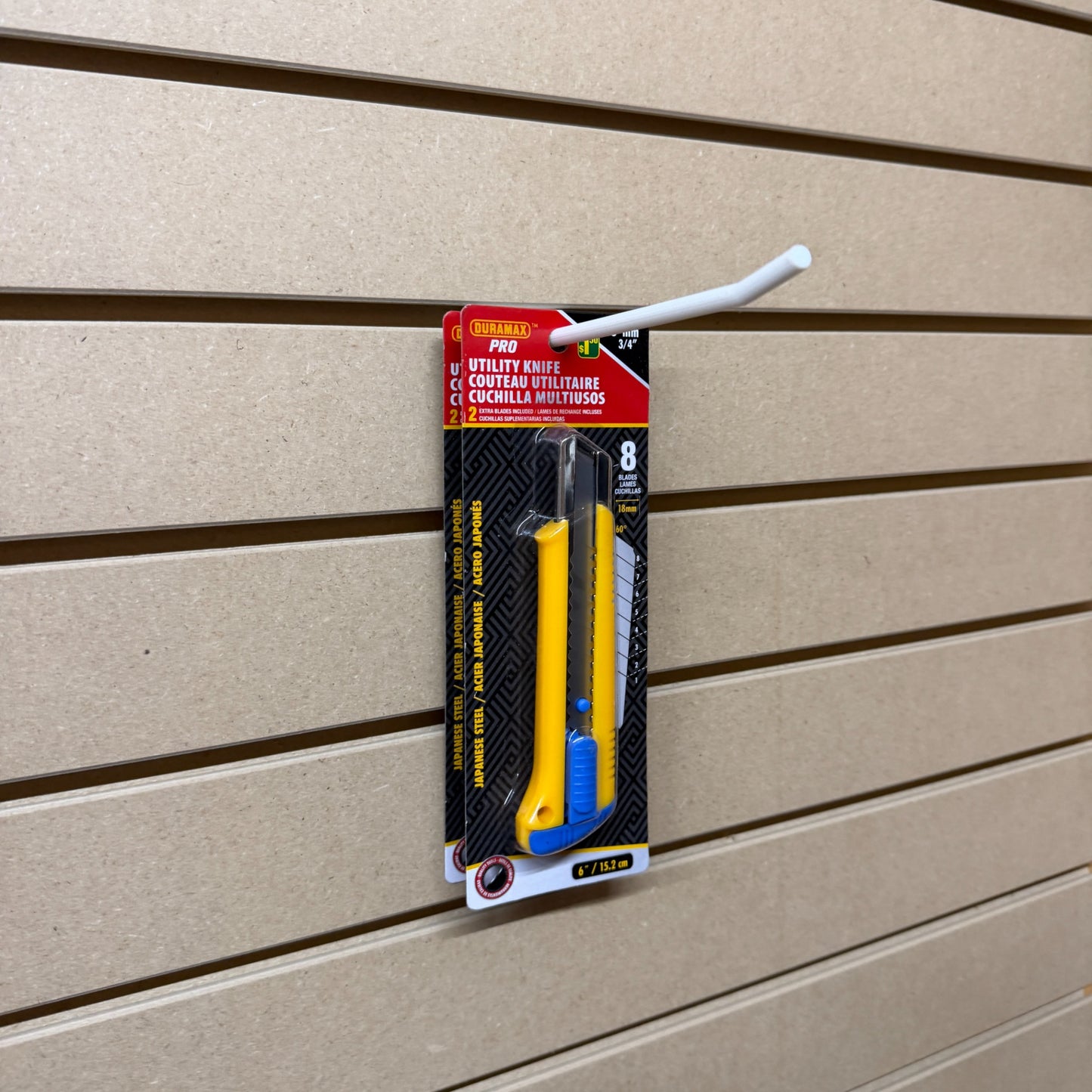 Ironleaf 6″ slatwall hook heavy duty reinforced polymer displaying utility knife packaging on slatwall.